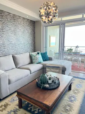 a living room with a couch and a coffee table at Portico 705 in Cape Town
