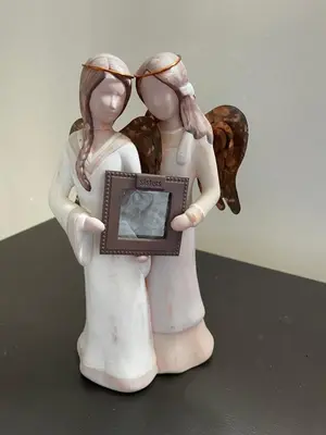 a figurine of two angels holding a picture at Sophia’s Cottage in Cape Town