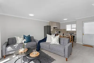 a living room with two couches and a table at Elegant, Spotless 2 Bed For Enchanted Stays in Cape Town