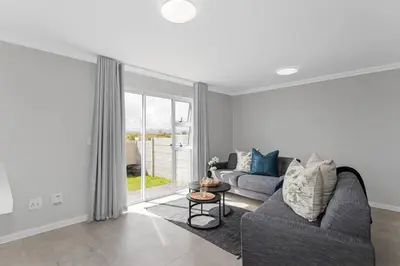 a living room with a couch and a table at Elegant, Spotless 2 Bed For Enchanted Stays in Cape Town