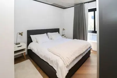 a bedroom with a large bed and a window at Modern apartment in Century City in Cape Town