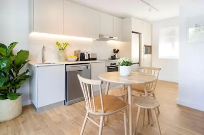 a kitchen with a table and chairs in a room at Middedorp Apartments in Stellenbosch