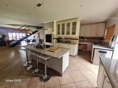 a kitchen with a island in the middle of it at Firlands Farmhouse 179A with a view in Sir Lowry Pass