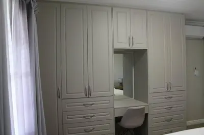 a white closet with a mirror and a chair at Firlands Farmhouse 179A with a view in Sir Lowry Pass