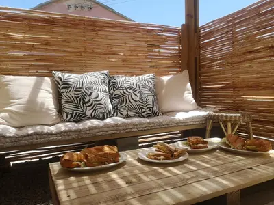 a couch with plates of food on a table at Coastal Cozy 2 in Cape Town