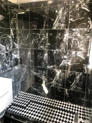 a black tiled bathroom with a black and white floor at Comfort and Style in Cape Town