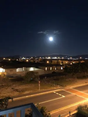 a view of a street at night with a full moon at Comfort and Style in Cape Town
