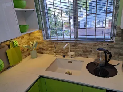 a kitchen counter with a sink and a window at Amatoni green apartment in Stellenbosch