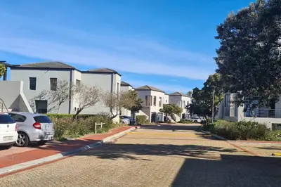 a row of houses with cars parked in a driveway at Waterside Townhouse in Cape Town