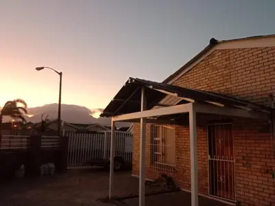 a brick house with a roof and a street light at Harmony Lawson Road in Cape Town
