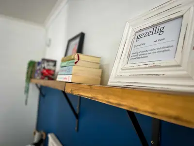 a wooden shelf with books on top of it at Spacious beachfront Townhouse w garage, Blouberg in Bloubergstrand