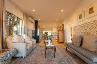 a living room with two couches and a table at Newly Renovated - Stellenbosch Farm Cottage in Stellenbosch