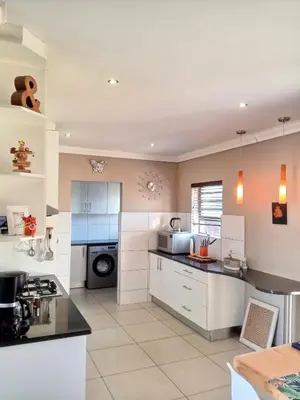 a large kitchen with white cabinets and appliances at Durbanville Luxury Living Private Room in Durbanville