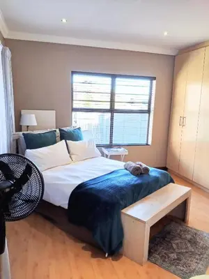 a bedroom with a large bed and a window at Durbanville Luxury Living Private Room in Durbanville