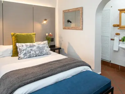 a bedroom with a bed and a sink at Loddey's Guesthouse by Beach Collection Winelands in Strand