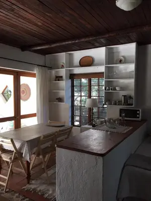 a kitchen with a table and chairs in a room at Haven of Peace and Garden Cottage in Hermanus