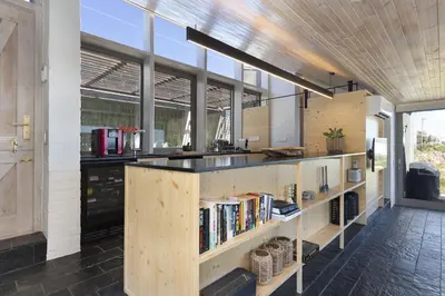 a kitchen with a counter with books at Hytte Riverview in Rooiels