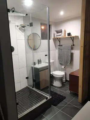 a bathroom with a glass shower and a toilet at Ruach 5 in Cape Town