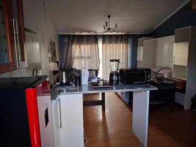a kitchen with a table with a microwave on it at Stay at Gabby's- no loadshedding in Cape Town
