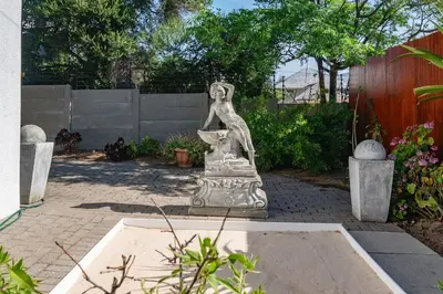 a statue of a woman sitting in a fountain at Apartment in Milnerton close to Woodbridge Island in Cape Town