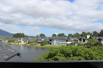 a view of a town with a river and houses at Pearl Valley Golf Lodge - loadshedding free in Simondium