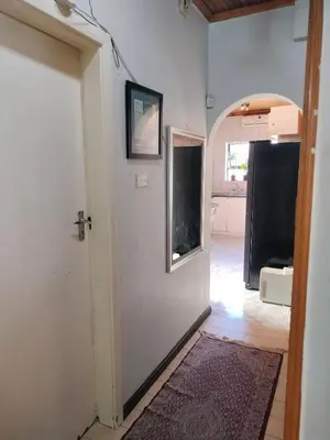 a hallway with a door leading to a kitchen at Near Grandwest in Cape Town
