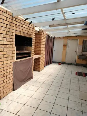 a large empty room with a brick wall and ceiling at Near Grandwest in Cape Town