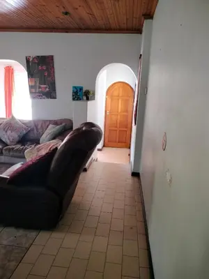 a living room with a couch and a wooden door at Near Grandwest in Cape Town