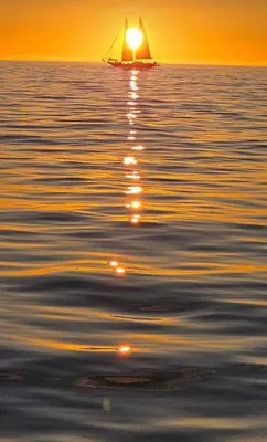 a sail boat on the water at sunset at Villa Georgia in Cape Town