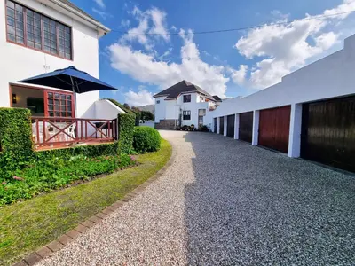 a walkway in front of a building with an umbrella at 2 Barford Haven in Hermanus