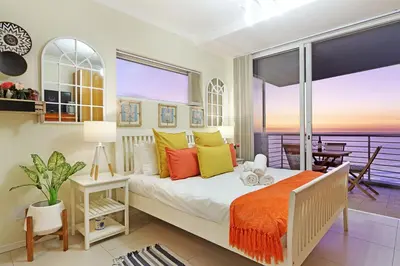 a bedroom with a bed with a view of the ocean at Horizon Bay 1201 in Bloubergstrand