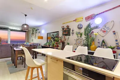 a kitchen and dining room with a fish tank on the counter at Horizon Bay 1201 in Bloubergstrand