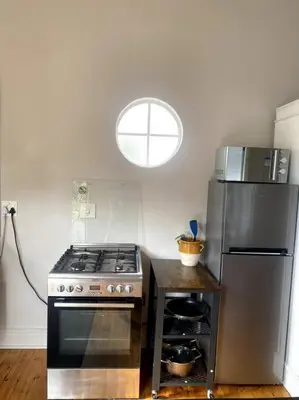 a kitchen with a stove and a refrigerator at Milner Cottage: Digital Nomad Oasis in Cape Town