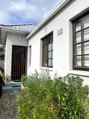 a white house with the number on it at Milner Cottage: Digital Nomad Oasis in Cape Town