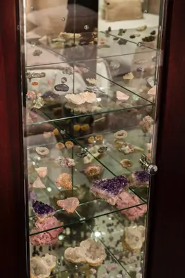 a glass display case filled with lots of rocks at Serviced Beach Penthouse, 100k Gemstone display, All Ensuite in Cape Town