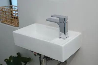 a white sink with a faucet on top of it at Oranje Meul in Paarl