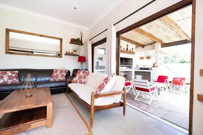 a living room with a couch and a table at La Haven Self Catering in Hermanus