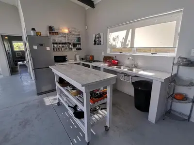 a kitchen with a counter and a sink and a counter top at Betty's Bay Cottage in Bettyʼs Bay