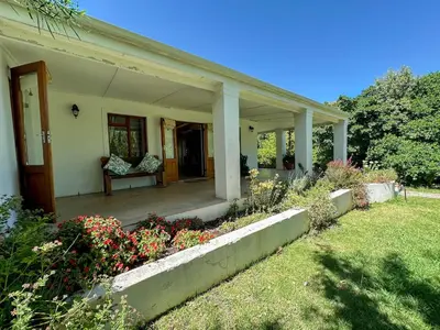 a front porch of a house with flowers at Arkelshoek Cottages in Stellenbosch