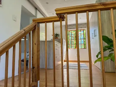 a wooden staircase in a home with a stair case at Arkelshoek Cottages in Stellenbosch