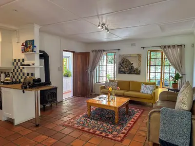 a living room with a couch and a table at Arkelshoek Cottages in Stellenbosch