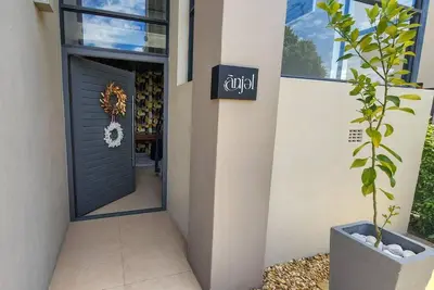 a door to a store with a potted plant next to it at House of Anjel in Suider-Paarl