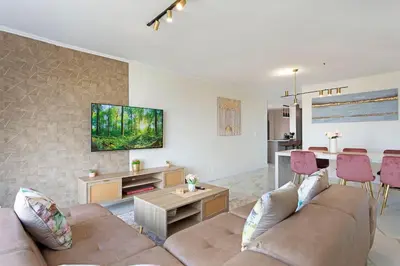 a living room with a couch and a table at 30% off Designer Penthouse - backup power - Cape Town in Cape Town