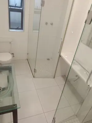 a white bathroom with a shower and a toilet at Cape Town 5 bedroom house Belhar in Cape Town