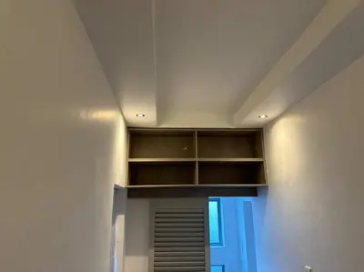 a room with a wall with shelves and a ceiling at Lemon House Modern duplex by UCT in Cape Town