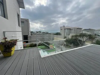 a balcony with a view of a house at Sunset Starfish Apartment in Cape Town