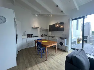 a kitchen with a table and a dining room at Sunset Starfish Apartment in Cape Town
