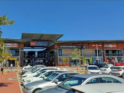 a parking lot full of parked cars in front of buildings at Gizelle in Cape Town