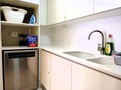 a kitchen with a sink and a dishwasher at 'Antilles'- 6 Bedroom Luxury Villa On The Beach, Sleeps 12 in Gordonʼs Bay