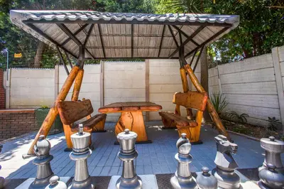a gazebo with chairs and a table and a chessboard at Suikerbos Guesthouse in Cape Town